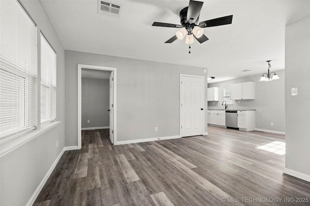 821 N 71st E Ave, Tulsa, OK 74115 - unfurnished living room with a chandelier, wood finished floors, ceiling fan, and a sink