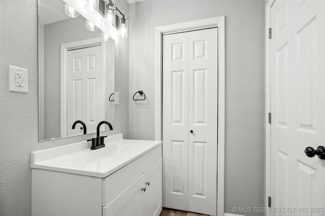 821 N 71st E Ave, Tulsa, OK 74115 - bathroom featuring vanity, a closet, and a textured wall