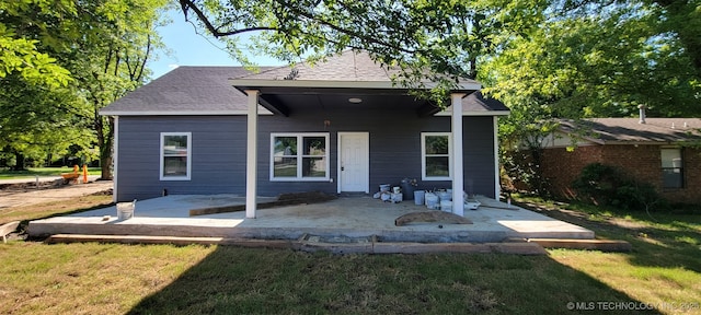 510 S Madison Ave, Wagoner, OK 74467 - rear view of property featuring a lawn, a patio, and roof with shingles