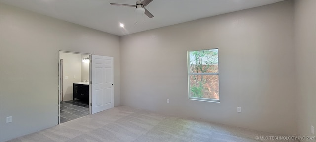 510 S Madison Ave, Wagoner, OK 74467 - unfurnished bedroom featuring light colored carpet, ensuite bathroom, and a ceiling fan