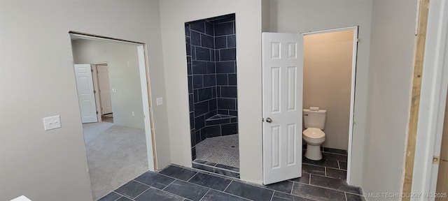 510 S Madison Ave, Wagoner, OK 74467 - bathroom with toilet, a tile shower, and tile patterned flooring