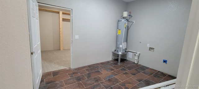 510 S Madison Ave, Wagoner, OK 74467 - laundry room with electric dryer hookup, water heater, washer hookup, and stone finish flooring