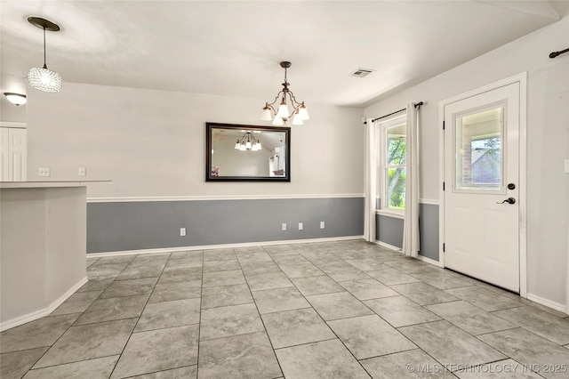 11604 E 99th St, Owasso, OK 74055 - unfurnished dining area with tile patterned flooring, baseboards, and a chandelier