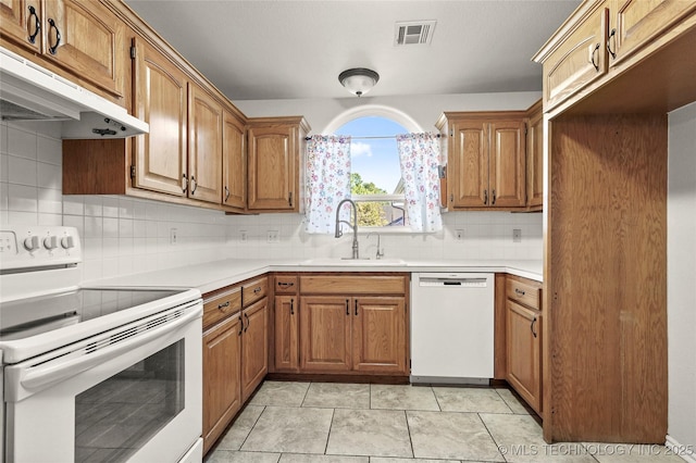 11604 E 99th St, Owasso, OK 74055 - kitchen with white appliances, a sink, under cabinet range hood, and tasteful backsplash