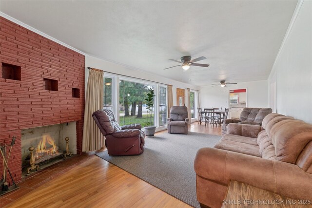 1401 E S Ave, Mcalester, OK 74501 - living area with a ceiling fan, plenty of natural light, wood finished floors, and a large fireplace