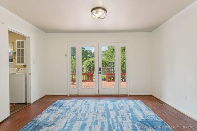1401 E S Ave, Mcalester, OK 74501 - unfurnished room with washing machine and clothes dryer, wood finished floors, french doors, ornamental molding, and baseboards