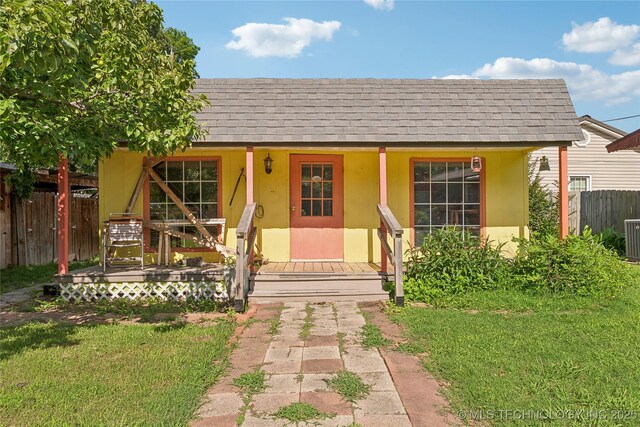 1401 E S Ave, Mcalester, OK 74501 - view of front of house featuring a shingled roof, a porch, central air condition unit, and stucco siding