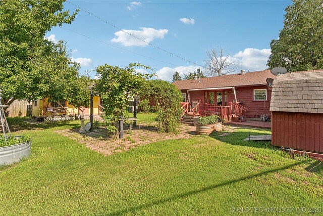 1401 E S Ave, Mcalester, OK 74501 - view of green lawn with a wooden deck and a garden