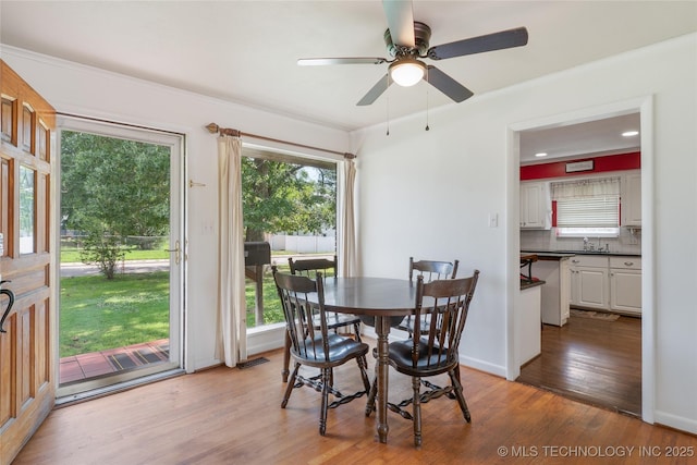 1401 E S Ave, Mcalester, OK 74501 - dining space with wood finished floors, a ceiling fan, and baseboards