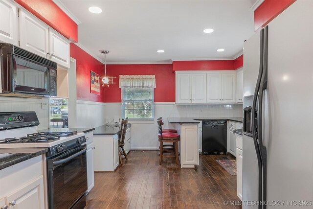 1401 E S Ave, Mcalester, OK 74501 - kitchen with black appliances, white cabinets, dark countertops, ornamental molding, and wainscoting