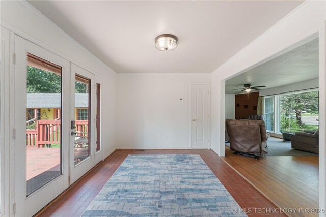 1401 E S Ave, Mcalester, OK 74501 - unfurnished room featuring dark wood finished floors, a ceiling fan, and baseboards