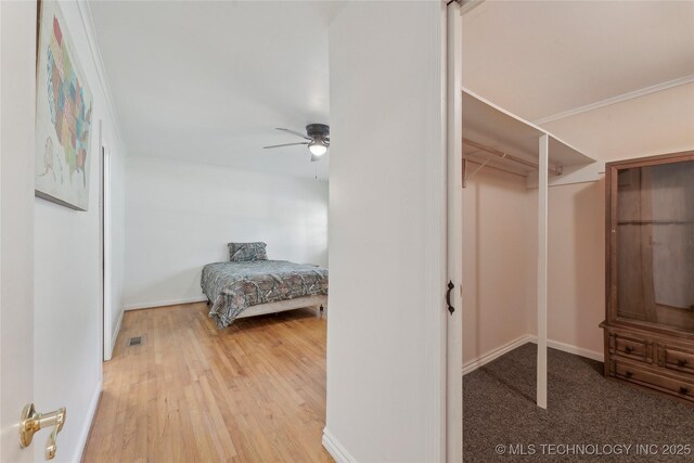 1401 E S Ave, Mcalester, OK 74501 - bedroom with light wood finished floors, ceiling fan, and baseboards