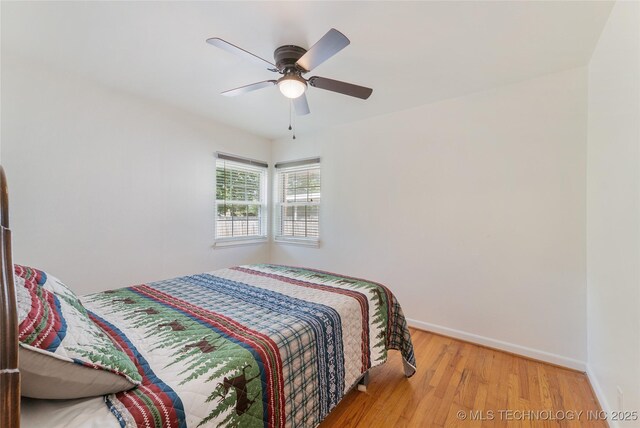 1401 E S Ave, Mcalester, OK 74501 - bedroom with wood finished floors, baseboards, and a ceiling fan