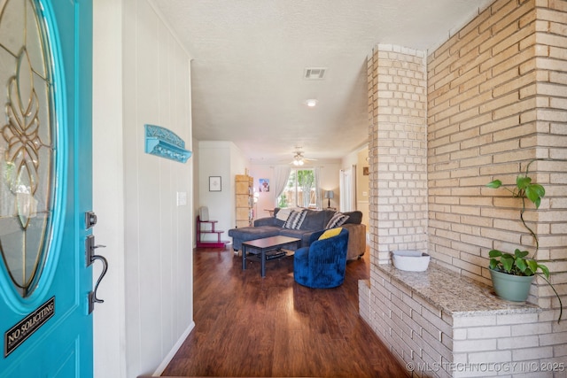 5212 S 68th E Pl, Tulsa, OK 74145 - entryway featuring dark wood-type flooring, brick wall, and a ceiling fan