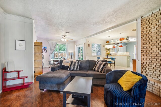 5212 S 68th E Pl, Tulsa, OK 74145 - living area featuring a textured ceiling, wood finished floors, a ceiling fan, and crown molding