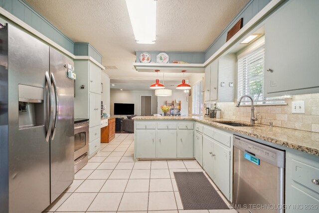 5212 S 68th E Pl, Tulsa, OK 74145 - kitchen featuring stainless steel appliances, a sink, a peninsula, light tile patterned floors, and open floor plan