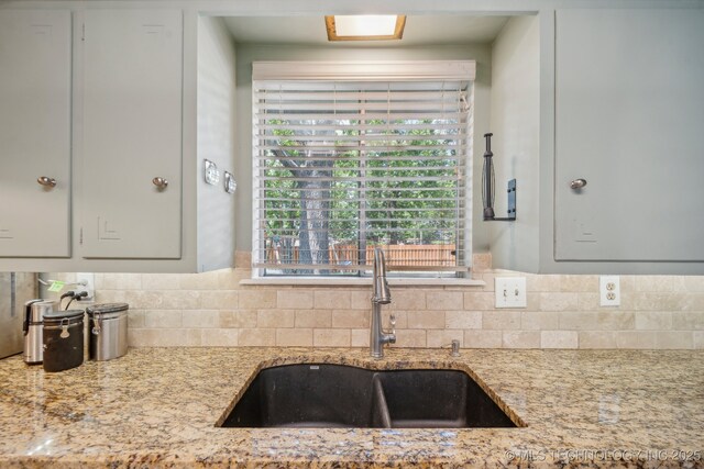 5212 S 68th E Pl, Tulsa, OK 74145 - kitchen featuring a sink, backsplash, and light stone countertops
