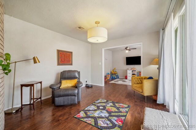 5212 S 68th E Pl, Tulsa, OK 74145 - living area with wood finished floors, a ceiling fan, baseboards, and a textured ceiling