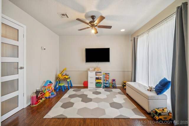 5212 S 68th E Pl, Tulsa, OK 74145 - game room with dark wood finished floors, a ceiling fan, and baseboards