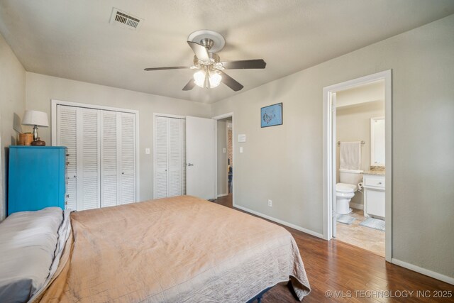 5212 S 68th E Pl, Tulsa, OK 74145 - bedroom with two closets, dark wood-style floors, baseboards, and ensuite bath