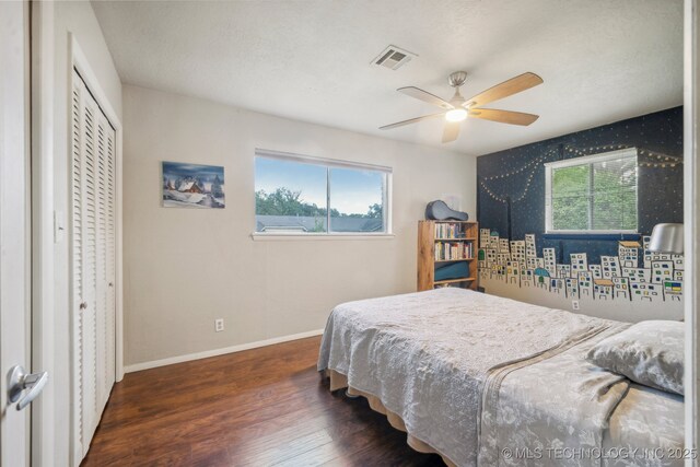 5212 S 68th E Pl, Tulsa, OK 74145 - bedroom with wood finished floors, baseboards, multiple windows, ceiling fan, and wallpapered walls