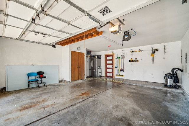 5212 S 68th E Pl, Tulsa, OK 74145 - garage with freestanding refrigerator and a garage door opener