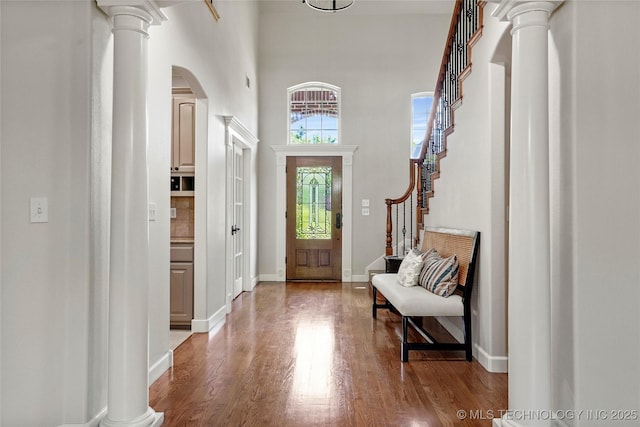 465 E 113th St S, Jenks, OK 74037 - foyer with decorative columns, arched walkways, wood finished floors, stairway, and a towering ceiling