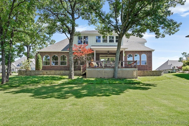 465 E 113th St S, Jenks, OK 74037 - back of house with brick siding, a yard, a ceiling fan, board and batten siding, and a wooden deck
