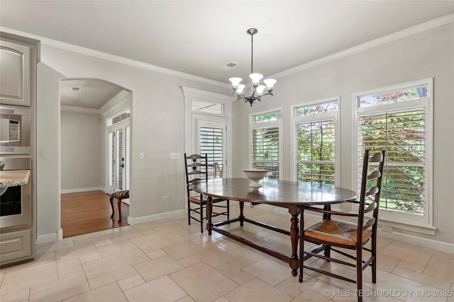 465 E 113th St S, Jenks, OK 74037 - dining room featuring arched walkways, ornamental molding, baseboards, and a chandelier