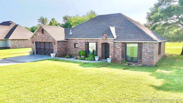 2102 N Peaceful Ln, Stigler, OK 74462 - view of front of home featuring brick siding, an attached garage, a front yard, roof with shingles, and driveway