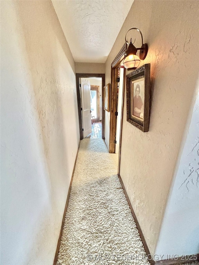 2102 N Peaceful Ln, Stigler, OK 74462 - corridor with a textured wall, light colored carpet, a textured ceiling, and baseboards