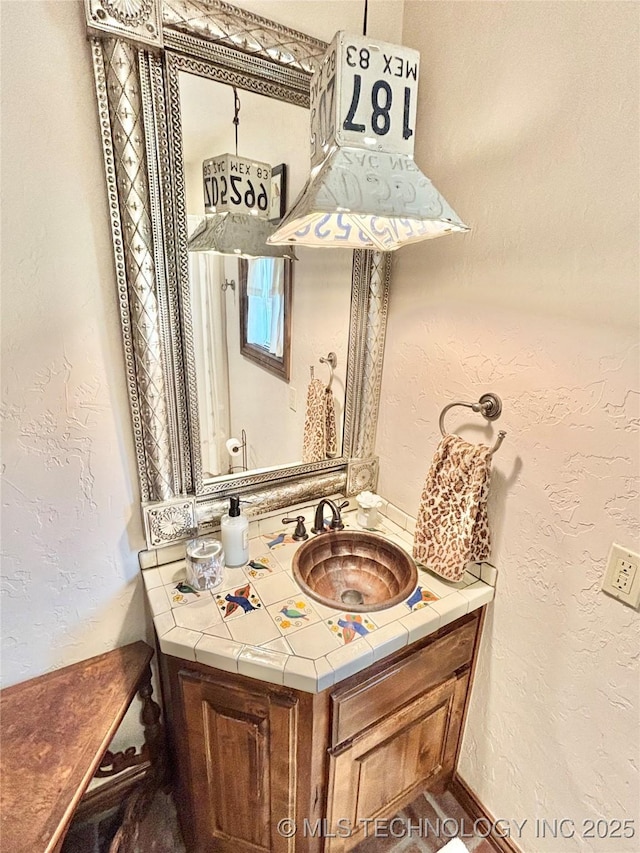 2102 N Peaceful Ln, Stigler, OK 74462 - bathroom with vanity and a textured wall