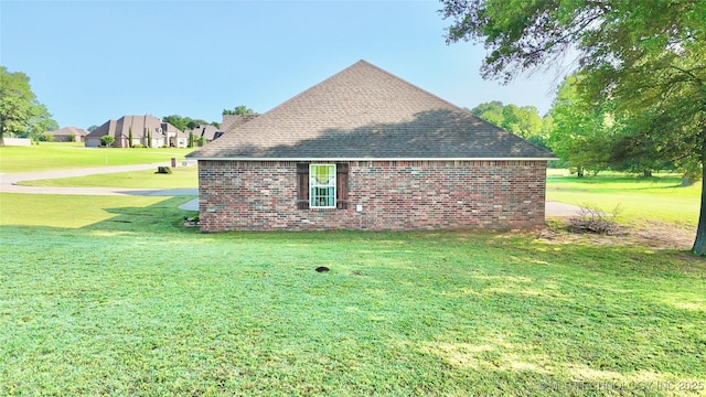 2102 N Peaceful Ln, Stigler, OK 74462 - view of property exterior with a lawn, a shingled roof, and brick siding