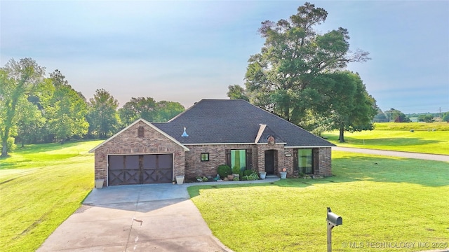 2102 N Peaceful Ln, Stigler, OK 74462 - french country style house with brick siding, a garage, concrete driveway, and a front lawn