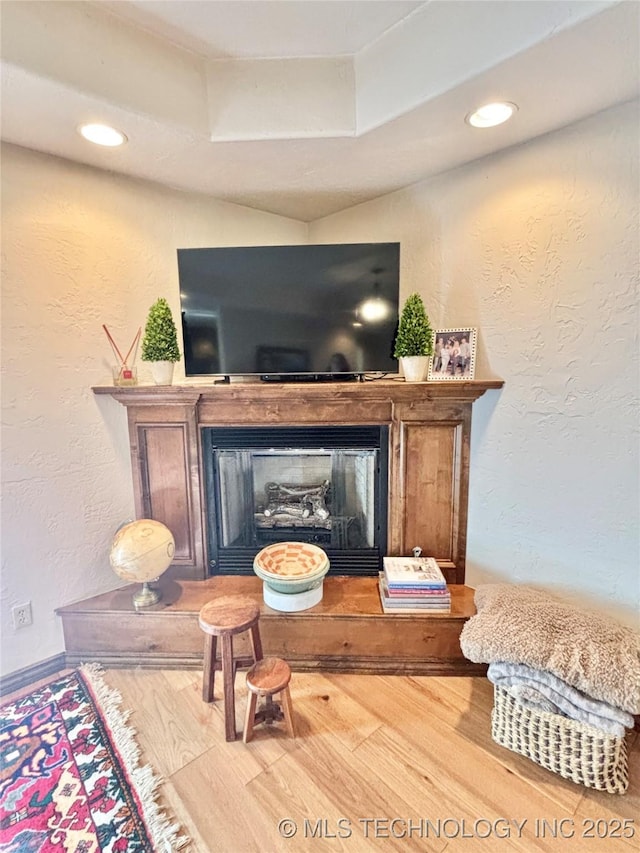 2102 N Peaceful Ln, Stigler, OK 74462 - detailed view of wood finished floors, a fireplace, a textured wall, recessed lighting, and baseboards