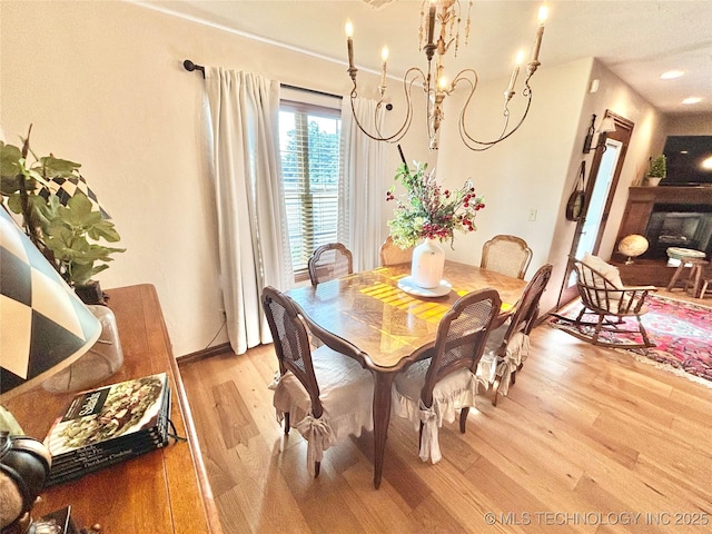 2102 N Peaceful Ln, Stigler, OK 74462 - dining area featuring light wood-style flooring, a chandelier, and baseboards