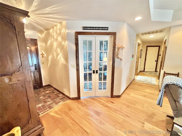 2102 N Peaceful Ln, Stigler, OK 74462 - hallway featuring baseboards, french doors, light wood finished floors, and recessed lighting
