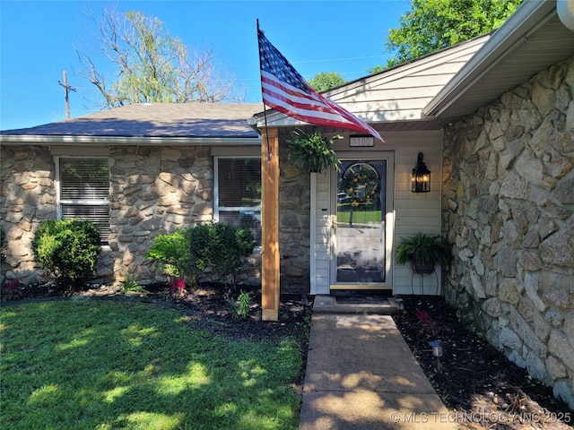 1100 Guinn Ln, Bartlesville, OK 74006 - doorway to property featuring stone siding and a yard