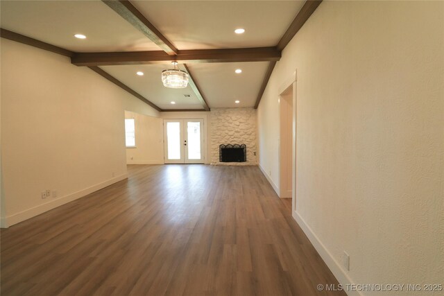 1100 Guinn Ln, Bartlesville, OK 74006 - unfurnished living room with baseboards, dark wood finished floors, recessed lighting, a chandelier, and a stone fireplace