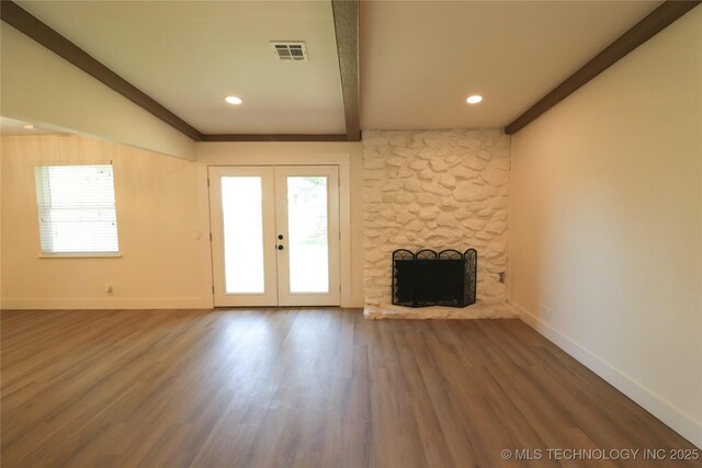 1100 Guinn Ln, Bartlesville, OK 74006 - unfurnished living room with baseboards, wood finished floors, french doors, a stone fireplace, and recessed lighting