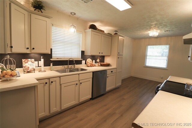 1100 Guinn Ln, Bartlesville, OK 74006 - kitchen featuring dishwasher, a sink, dark wood-type flooring, light countertops, and electric range