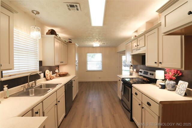 1100 Guinn Ln, Bartlesville, OK 74006 - kitchen featuring appliances with stainless steel finishes, a sink, under cabinet range hood, and light countertops