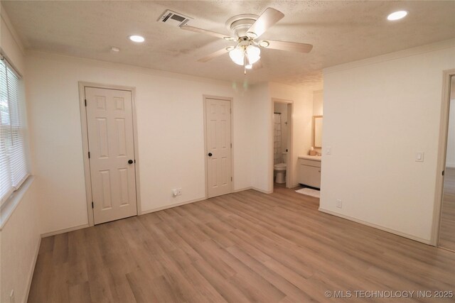 1100 Guinn Ln, Bartlesville, OK 74006 - unfurnished bedroom featuring recessed lighting, light wood-type flooring, ornamental molding, ensuite bathroom, and baseboards