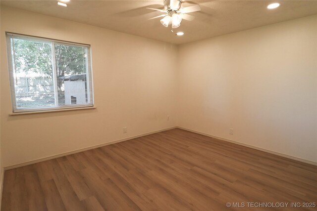 1100 Guinn Ln, Bartlesville, OK 74006 - empty room featuring a ceiling fan, recessed lighting, wood finished floors, and baseboards