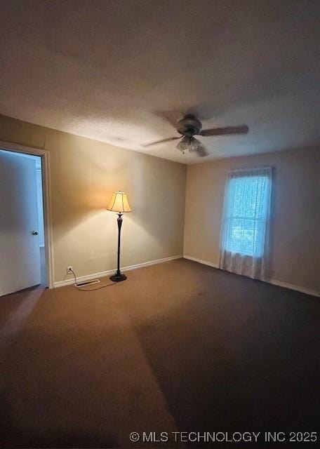 607 3rd NW, Ardmore, OK 73401 - empty room with dark carpet, ceiling fan, and baseboards