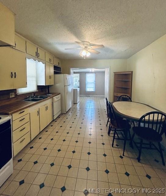 607 3rd NW, Ardmore, OK 73401 - kitchen with a sink, white appliances, ceiling fan, a textured ceiling, and dark countertops