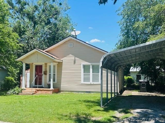 607 3rd NW, Ardmore, OK 73401 - ranch-style house with a detached carport and a front yard