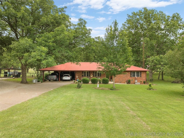 1307 Chickasaw Rd, Calera, OK 74730 - view of front of house with concrete driveway, a front yard, a carport, and a metal roof