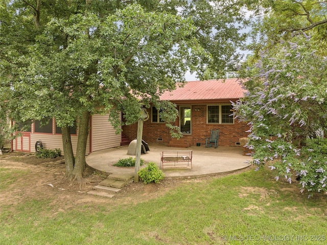 1307 Chickasaw Rd, Calera, OK 74730 - rear view of property featuring a patio area, a lawn, crawl space, a metal roof, and brick siding