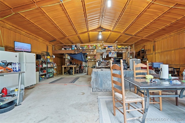 1307 Chickasaw Rd, Calera, OK 74730 - miscellaneous room with a workshop area, unfinished concrete floors, vaulted ceiling, and a garage